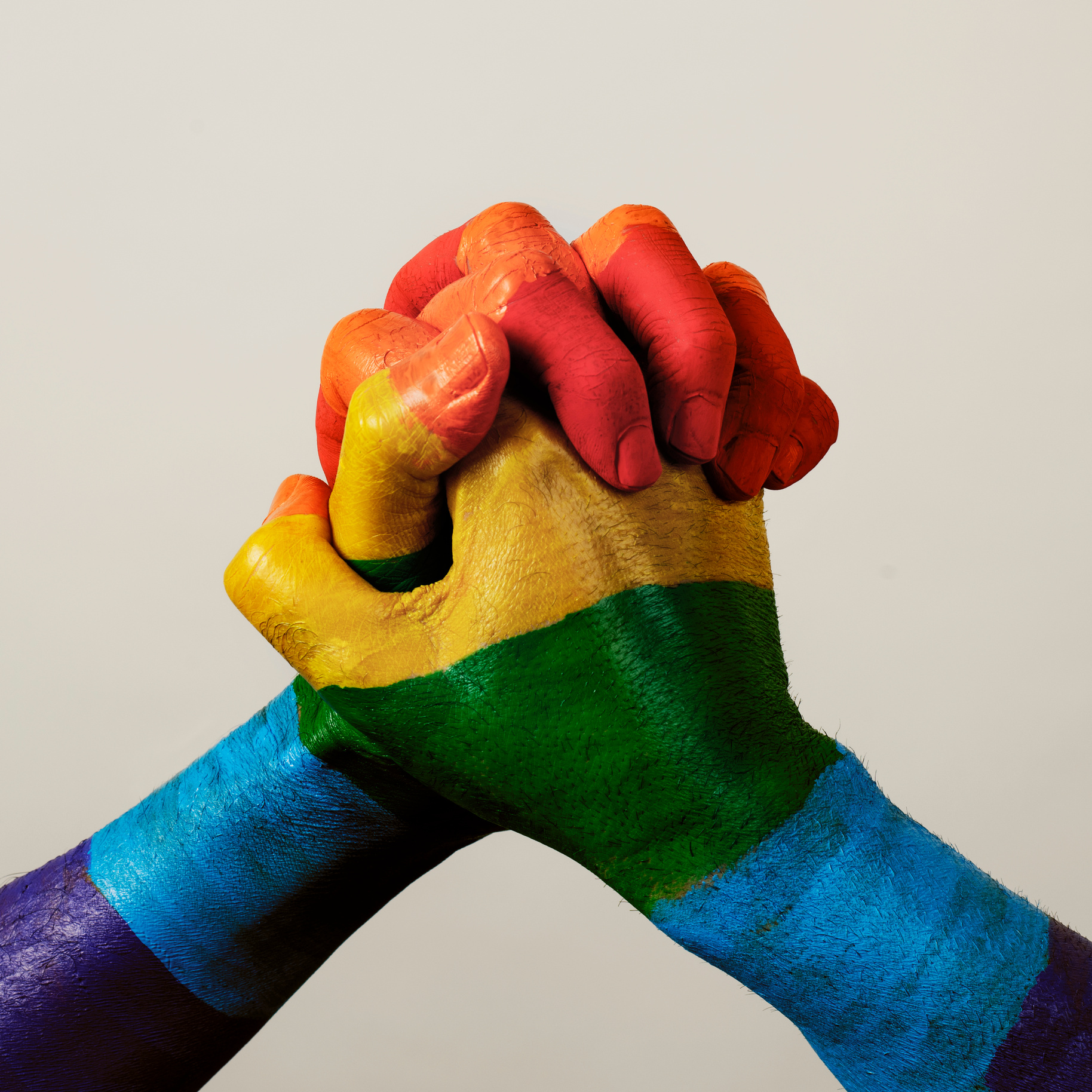 Hands Patterned with the Rainbow Flag