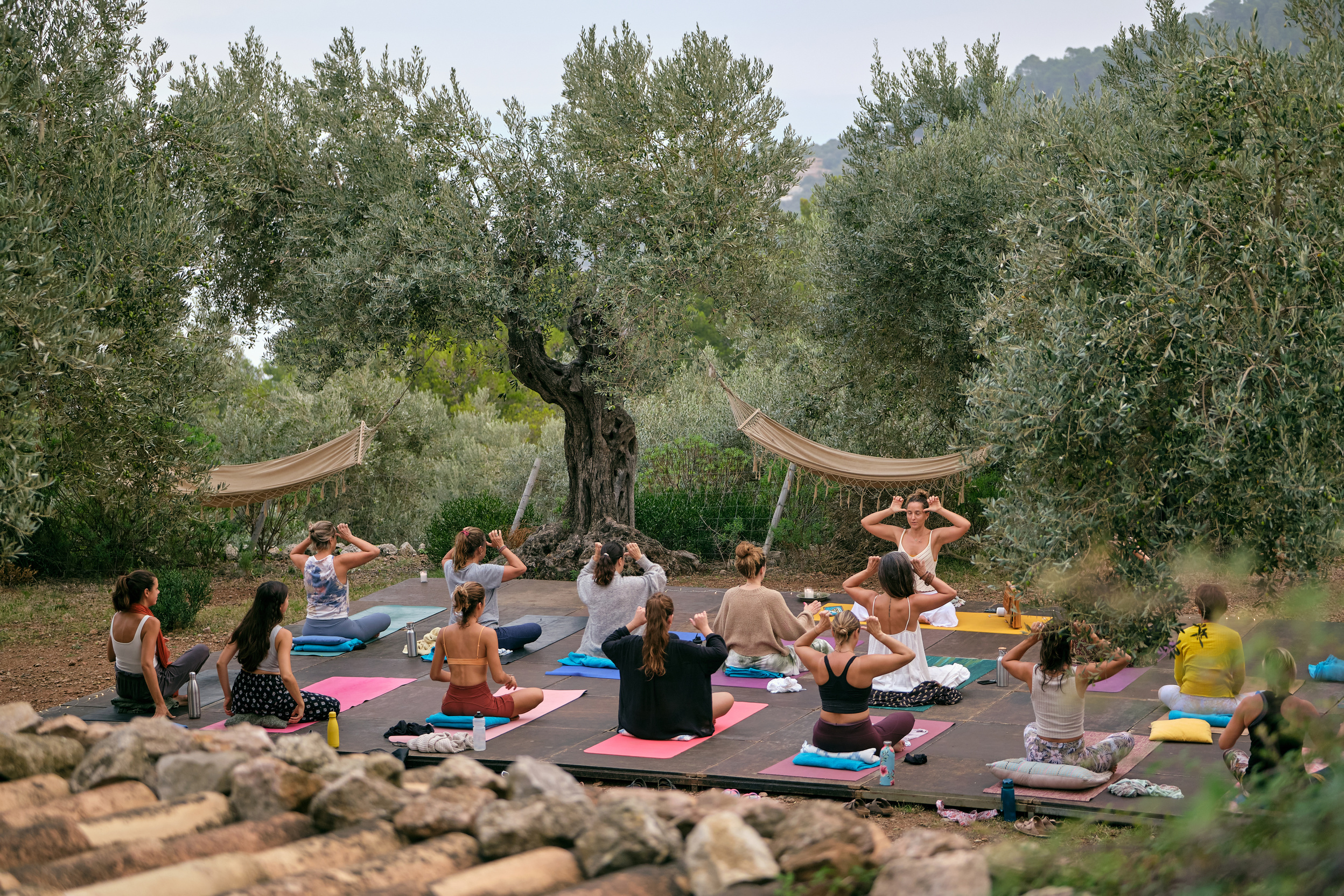 Women practicing yoga in countryside