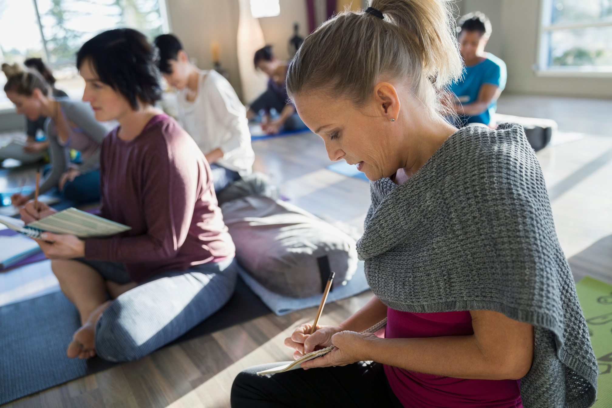 Women with journals at restorative yoga retreat